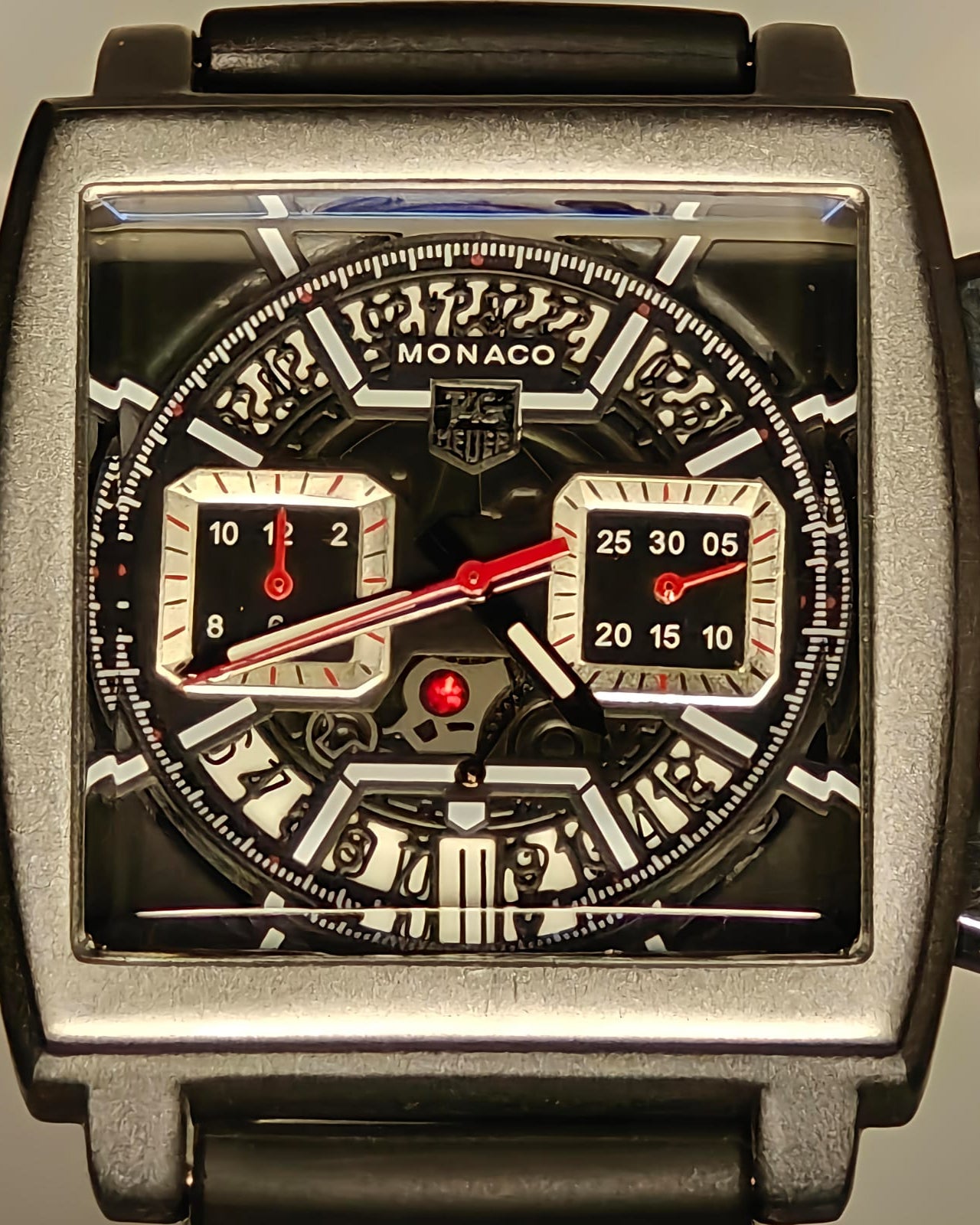 Monaco watch with detailed face and brand logo on a reflective surface